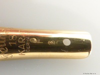 Nib with an importer punch (TK and symbol of the earth) and test mark (curculionidae)